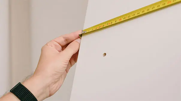 Mains qui prennent des mesures avec un mètre mesureur